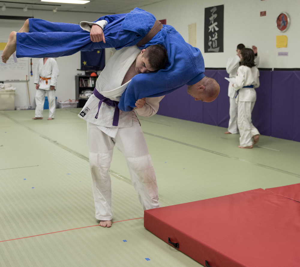 Cody Weldon throws instructor Luke Fortier during judo practice at the Capital City Judo dojo on Tuesday.