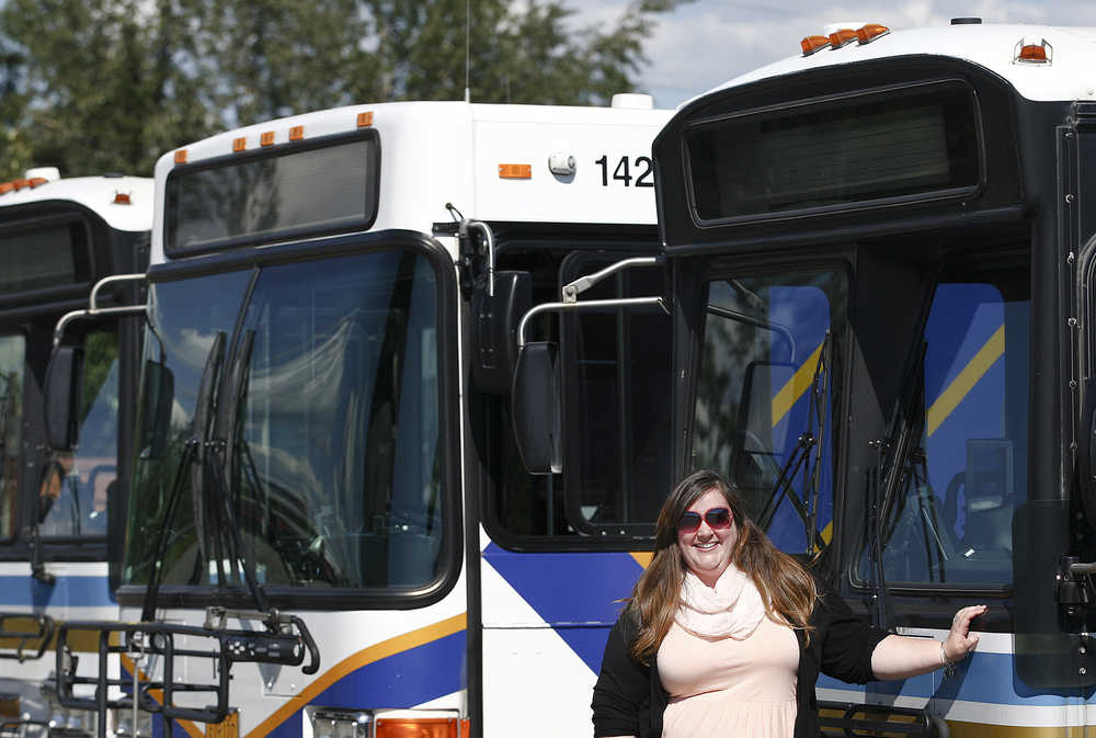 In this July 13 photo, Michelle Felix, the new Transportation Manager for the Fairbanks North Star Borough, poses for photos in front of some of the MACS Transit Buses at the Borough Transportation Building.