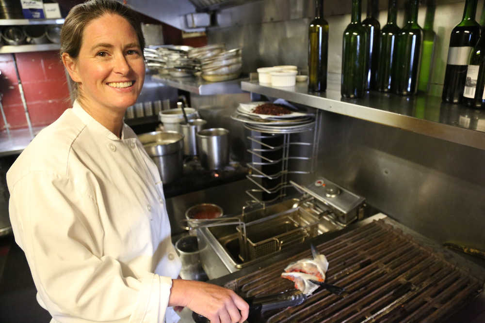 Colette Nelson, owner and executive chef of Ludvig's Bistro in Sitka, cooks a pair of salmon collars in the restaurant kitchen. Nelson is headed to New Orleans next week to compete in the annual Great American Seafood Cook-Off.