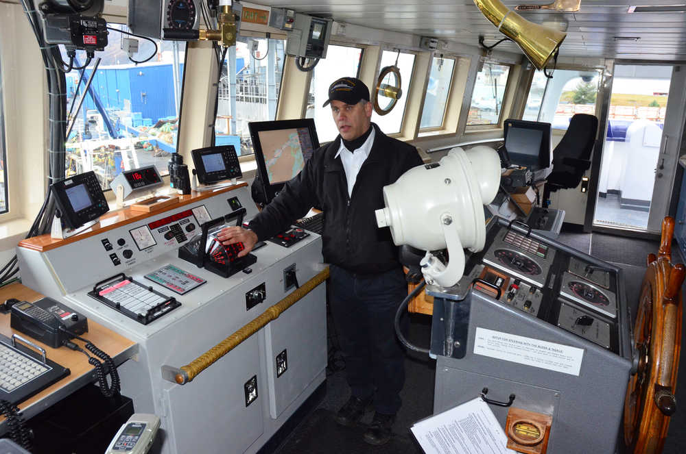 Tustumena captain John Mayer explains the improvements to the ship's wheelhouse Monday, Oct. 21, 2013. (James Brooks photo)