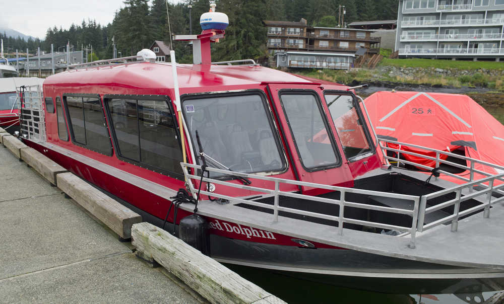 A 25-person inflated life-boat sits next to a Dolphin Jet Boat Tours whale-watching boat tied up at the Statter Memorial Boat Harbor in Auke Bay on Monday. One of the companies boat sunk on the south end of Aaron Island on Sunday. Eighteen people were rescued with one minor injury reported.