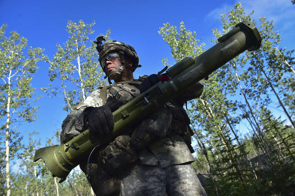 This July 25, 2016, photo provided by the U.S. Air Force shows Spc. Sixto Carrasquiollo, a native of New York City, assigned to A Company, 1st Battalion, 24th Infantry Regiment, 1st Stryker Brigade Combat Team, 25th Infantry Division, U.S. Army Alaska, holding an AT-4 anti-armor weapon while listening to orders to occupy defensive positions during a war games simulation at Donnelly Training Area near Ft. Greely, Alaska. More than 5,000 soldiers and support personnel took part in the Arctic Anvil training exercise, the largest to be held in Alaska in about 15 years. (Justin Connaher/U.S. Air Force via AP)