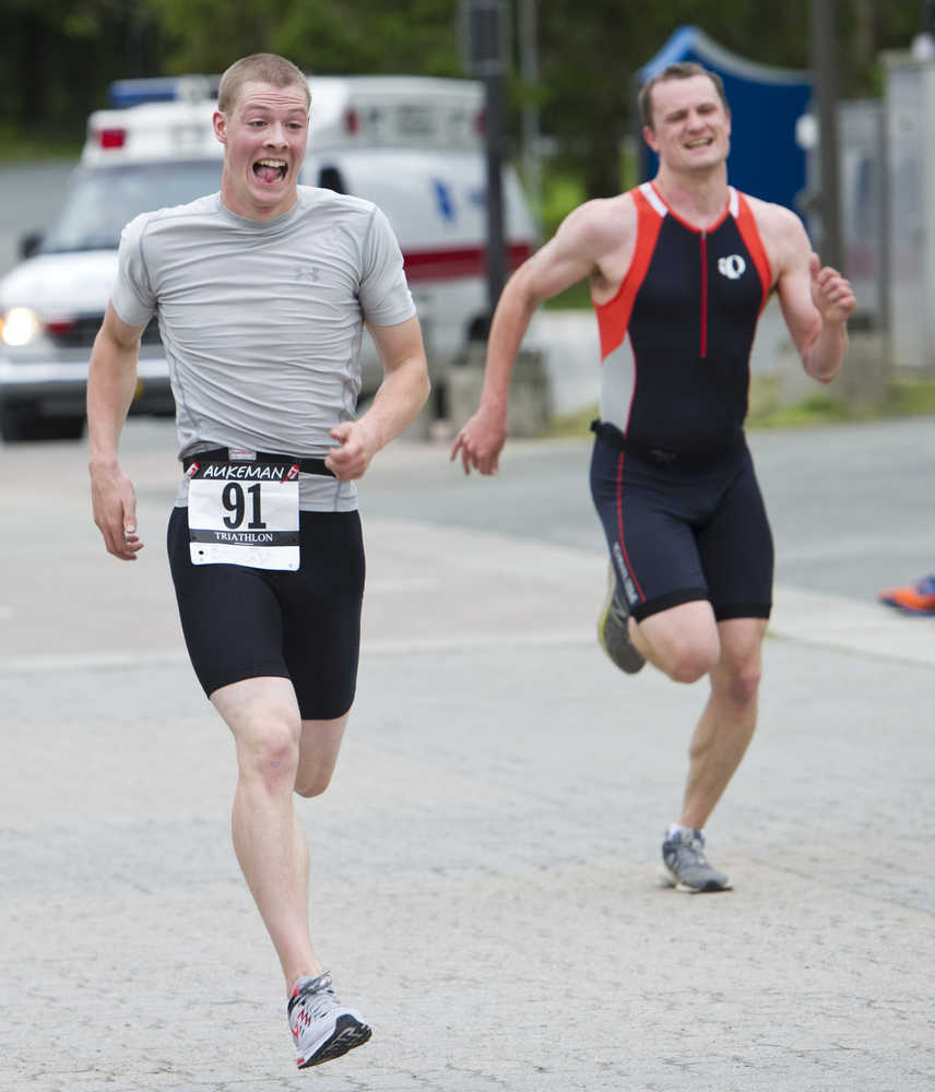 Kenny Fox out sprints Justin Dorn at the finish line of the 8th annual Aukeman Sprint Triathlon at the University of Alaska Southeast on Saturday.