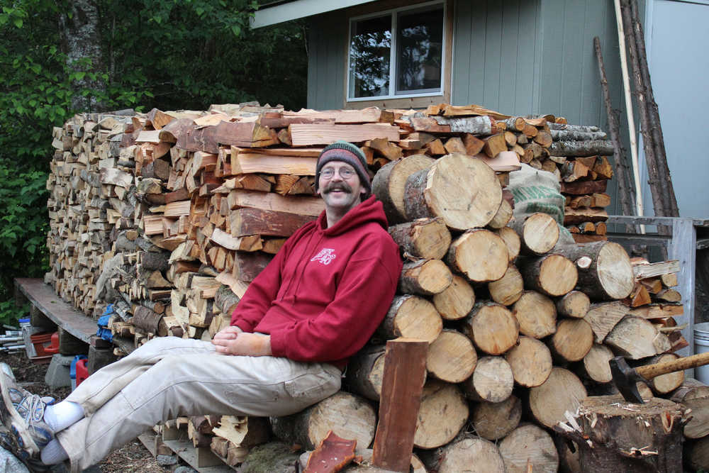 Woodshed Kings columnist Dick Callahan with a woodpile stocked to last the winter.