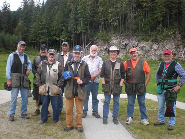 Aug. 6 trap shooters from left to right: Mal Menzies, Chip Verrelli, Fred Bergander, Mer'Chant Thompson, Garret Hermann, Fred Wilson, Pete Hudson, Jerry Godkin and Wayne Bertholl.  Note jr. trap shooter Garret Hermann holding his ceremonial hat and his 25 straight patch.