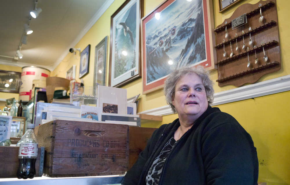 Suzanne Hudson, owner of Nana's Attic, waits for customer to visit her Seward Street antique shop on Tuesday. Her shop of burglarized in December 2014 with $5,000 worth of valuables stolen and smashed display cases.