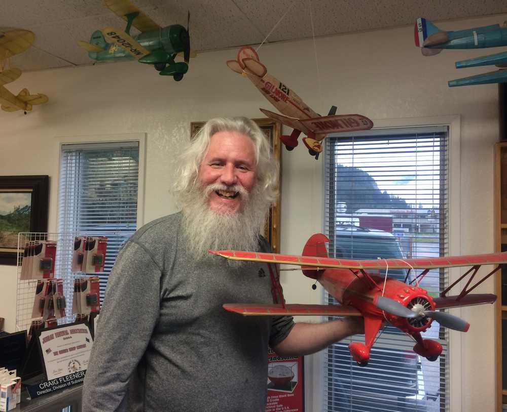 Jim Miller, owner of the Juneau Rubber Stamp Co. and father of this photographer, shows off a Waco YMF-5 bi-plane.