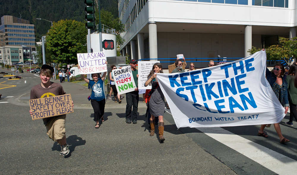 In this Aug. 27, 2015 photo, protesters march down Main Street after a rally on the steps of the Alaska State Capitol to bring attention to the long-term protection of transboundary waters, principally the Taku, Stikine and Unuk watersheds.