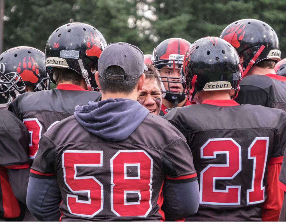 The Crimson Bears huddle during a game Aug. 13 against Thunder Mountain High School. The team will face the Kodiak High School Bears at 6 p.m. Friday at Adair Kennedy Field.