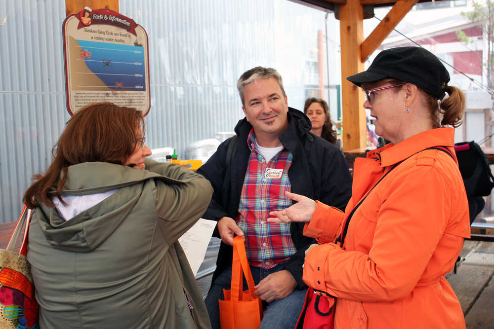 Juneau Food Tours owner Midgi Moore talks to two of her customers at Tracy's King Crab Shack, the first tasting of the day.