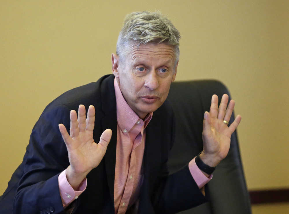 In this May 18 photo, Libertarian presidential candidate and former New Mexico Gov. Gary Johnson speak with legislators at the Utah State Capitol in Salt Lake City.