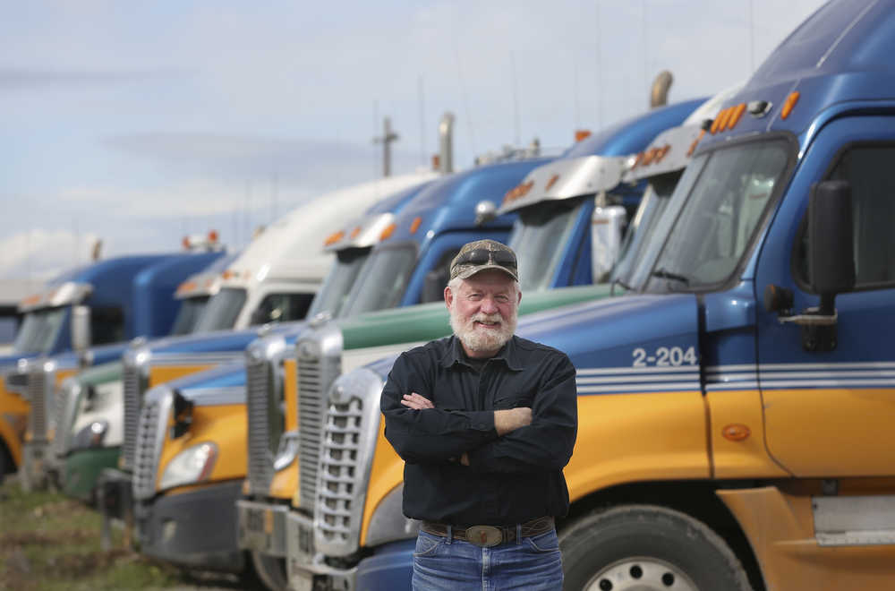 In this Aug. 12 photo, Jack Binder, a trainer, mentor and longtime truck driver, stands by trucks at Alaska West Express in Fairbanks. Driving trucks on the Dalton Highway is an adventure, which is why Binder has braved the famed highway since it opened in 1974.