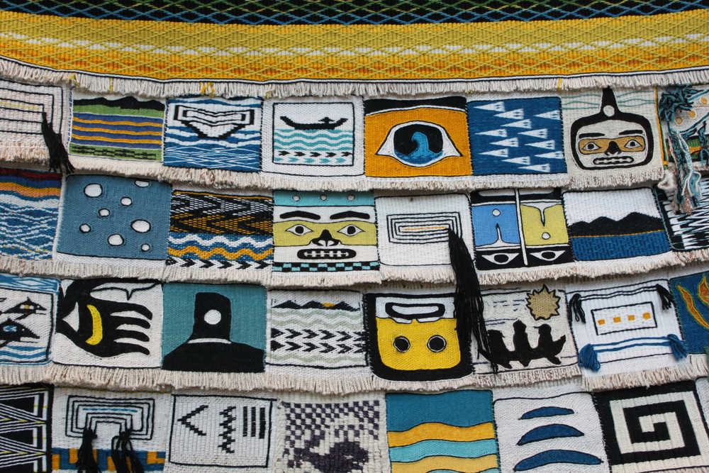 This is part of the "Weavers Across the Water" robe that will be debuted at the dedication of Xunaa Shuká Hít in Glacier Bay. Forty Ravenstail and Chilkat weavers from around the Pacific Northwest contributed a square measuring around five inches by five inches. Master weaver Clarissa Rizal wove the border around the robe, a pattern called "Mating Loons." The robe will get its first use during the dedication ceremony for Xunaa Shuká Hít, the Glacier Bay tribal house.