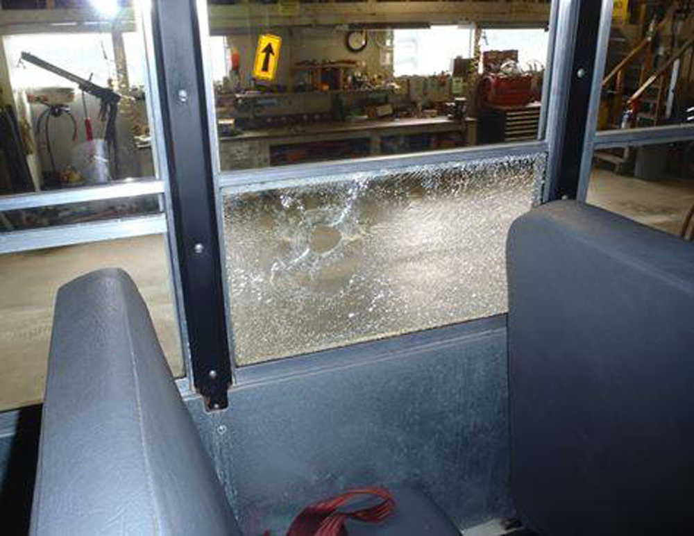 In this courtesy photo from the Juneau Police Department, a bullet hole is seen in a First Student school bus after a 21-year-old Juneau man fired a 9mm Glock from inside a home in the 9200 block of Sharon Street, not realizing the gun was loaded. Two children, a bus driver and a bus aide were on the bus, but no injuries were reported.
