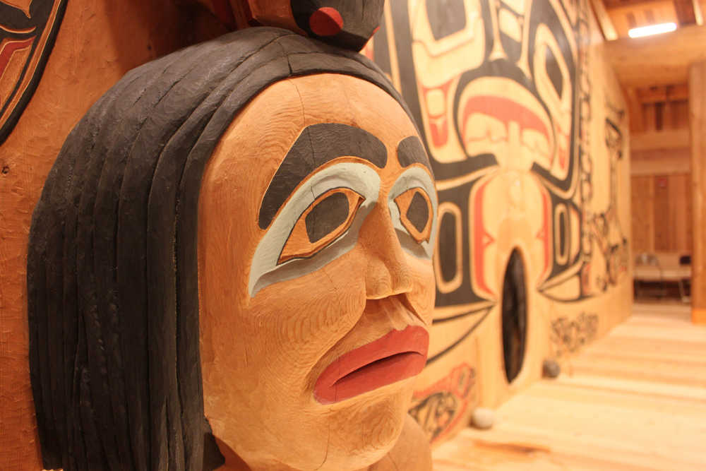 A face on an interior house post in Xunaa Shuká Hít. Each house post represents one of Glacier Bay's four original clans. In the background is the interior house screen.