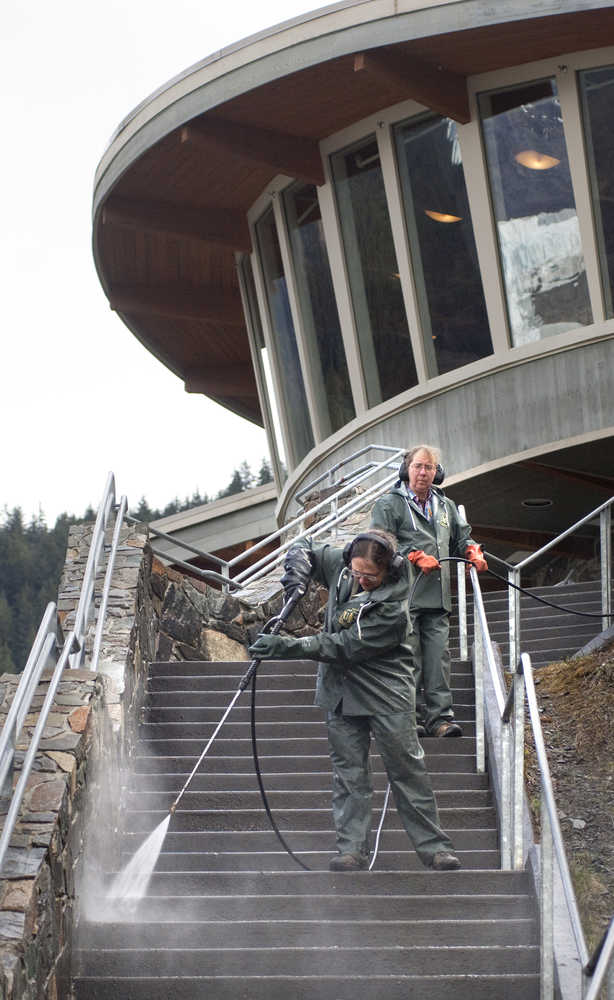 Jane Terry, left, and Brenda Wright powerwash the steps leading up to the Mendenhall Glacier Visitors Center on Monday.