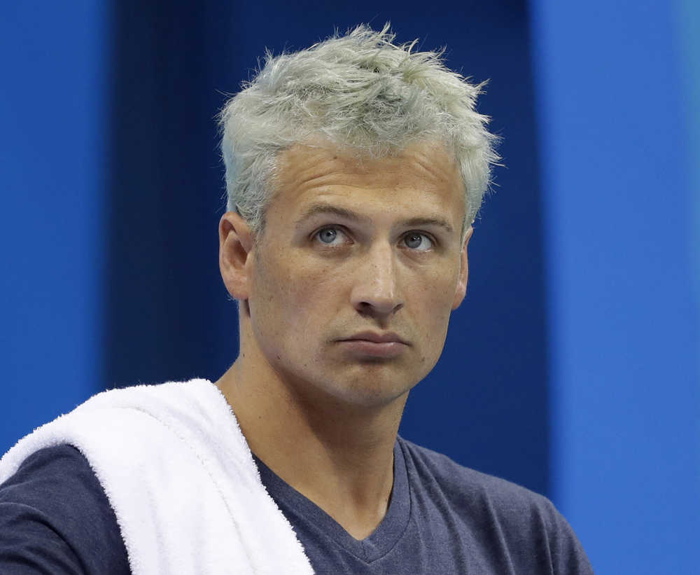 FILE - In this Aug. 9, 2016, file photo, United States' Ryan Lochte prepares before a men's 4x200-meter freestyle heat at the 2016 Summer Olympics, in Rio de Janeiro, Brazil. Lochte is banned from swimming through next June and will forfeit $100,000 in bonus money that went with his gold medal at the Olympics, part of the penalty for his drunken encounter at a gas station in Brazil during last month's games. The U.S. Olympic Committee and USA Swimming announced the penalties Thursday. Sept. 8, 2016. (AP Photo/Michael Sohn, File)