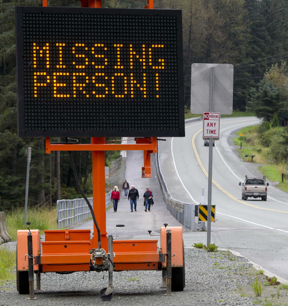 Volunteer searchers look along Auke Lake for missing Ryan Harvey, 22, on Thursday.