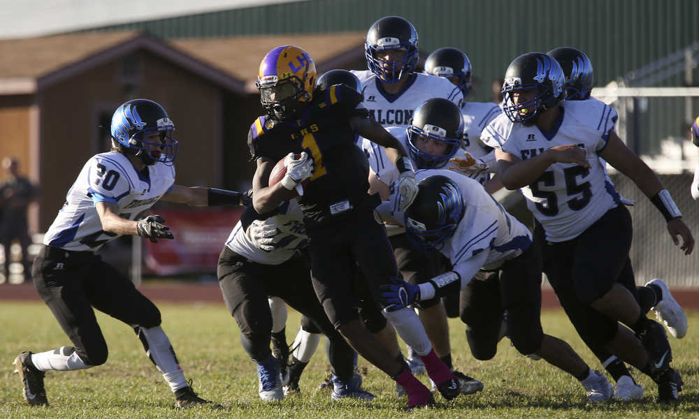 Lathrop's RJ Henry runs the ball during a game against Thunder Mountain at Lathrop High School on Saturday, September 10, 2016. ERIN CORNELIUSSEN/NEWS-MINER
