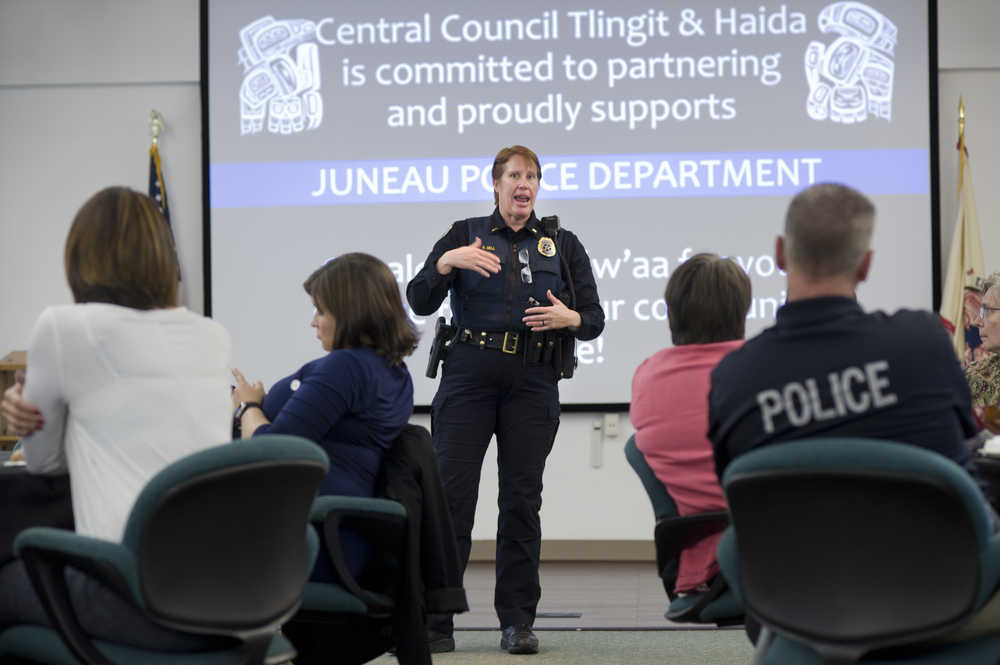Lt. Kris Sell gives people attending the Juneau Police Department's Coffee with a Cop a briefing Tuesday on the department's search for Christopher Orcutt, 22.