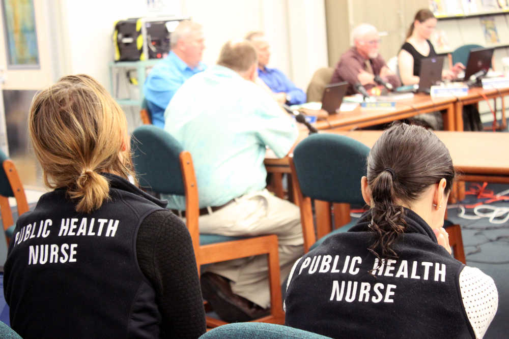 Two public health nurses listen as the Juneau School Board Tuesday night discusses approving a list of individuals that will be allowed to teach sex education. The approval process is newly mandated under House Bill 156.