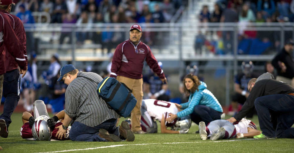 Three injuried Ketchikan players are care for in the second quarter at Thunder Mountain High School on Friday. With Thunder Mountain up 21-0 in the second quarter Ketchikan walked off the field citing unfair refereeing after multiple injuries to Ketchikan players. Two Ketchikan players were taken to Bartlett Regional Hospital.