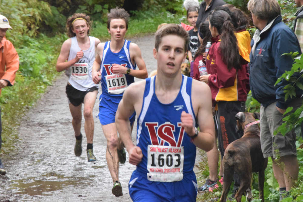 Juneau-Douglas High School's Arne Ellefson-Carnes, left, attempts to catch Sitka's Collin Bociocco, right, and David Wilcox, middle, at Saturday's Juneau Invitational cross country meet at Savikko Park.