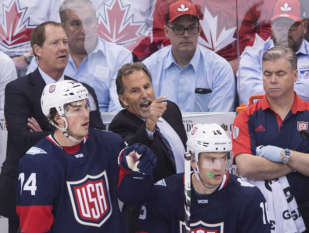 Team USA head coach John Tortorella, center, yells as Team USA players T.J. Oshie (74) and James van Riemsdyk (16) as assistant coach Phil Housley, back left, watch the game against Canada during third period World Cup of Hockey action in Toronto on Tuesday, Sept. 20, 2016. (Nathan Denette/The Canadian Press via AP)