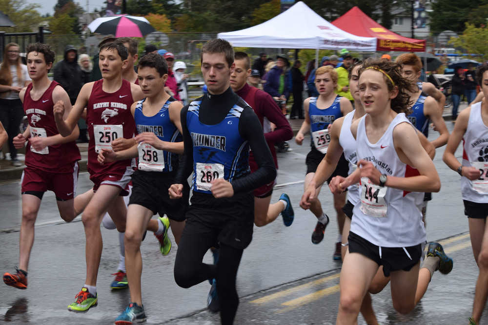 Juneau-Douglas High School's Arne Ellefson-Carnes, right, and Thunder Mountain High School's Justin Sleppy, middle, jockey for position a the start of Saturday's Region V cross country championship in Sitka.