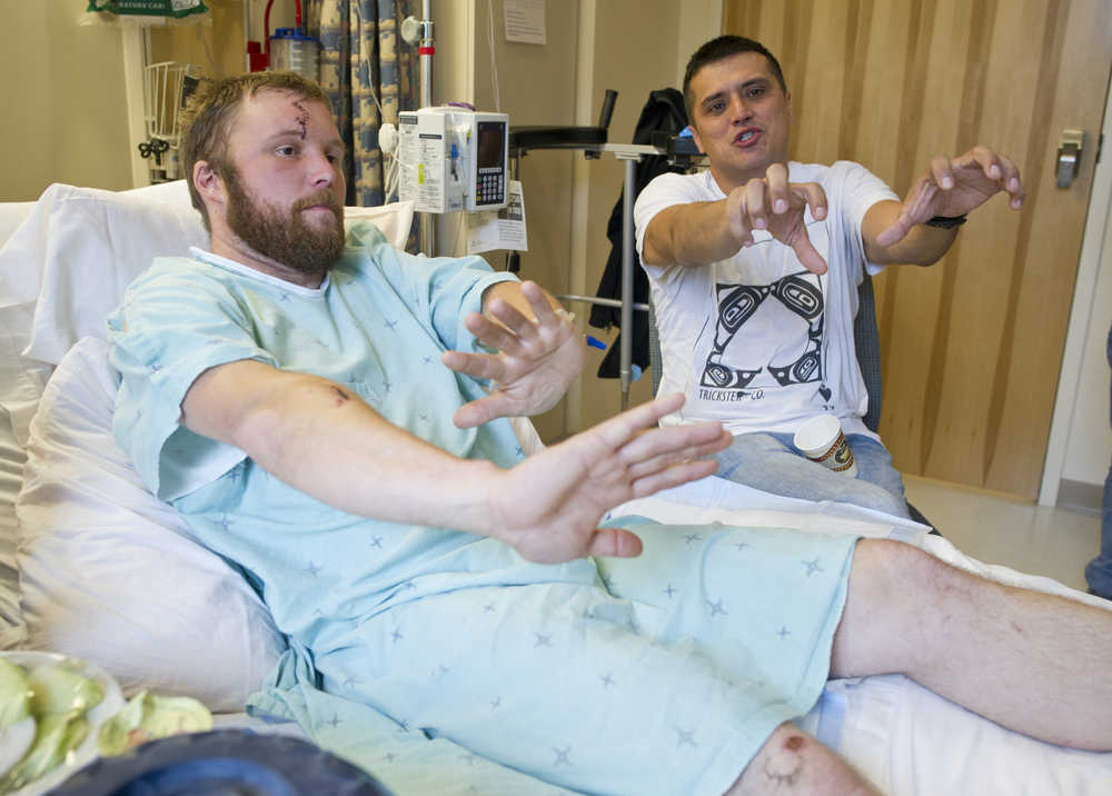 Josh Dybdahl, 30, and Anthony Lindoff, 36, tell their story at Bartlett Regional Hospital on Tuesday after being attacked by a brown bear sow with cubs on Chichagof Island during a deer hunting expedition on Saturday. Dybdahl was being mauled when Lindoff shot and killed the bear.