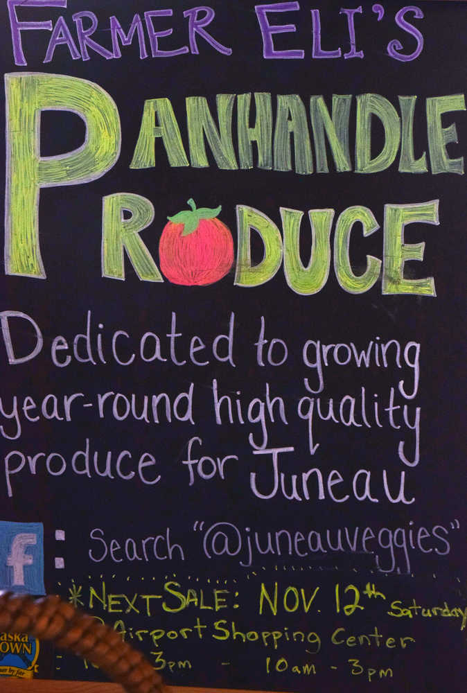 A sign advertising Panhandle Produce, seen at Eli and Kylie Wrays' booth at the Second Saturday Market in teh Airport Shopping Center Saturday morning.