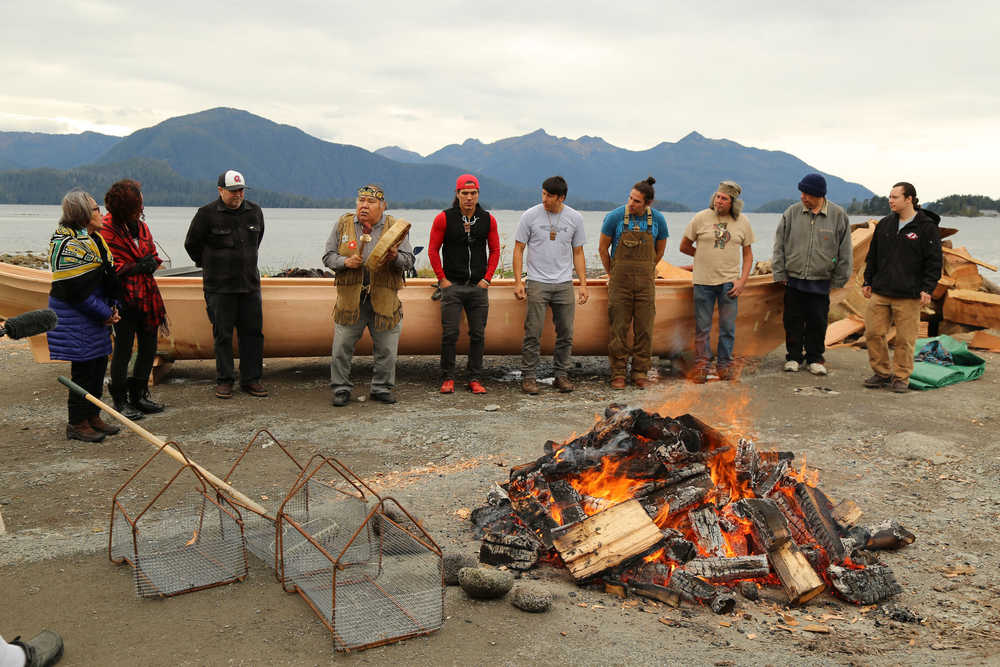 From left to right, Sealaska Heritage Institute president Rosita Worl; Juneau artist Crystal Worl; Sitka Tribe of Alaska Youth Coordinator Chuck Miller; Shangukeidí clan leader David Katzeek; carvers T.J. Young, Jerrod Galanin, Nick Galanin, and Tommy Joseph; Ed Malline, and Zak D. Wass stand in front of the canoe. Katzeek and Rosita Worl flew to the steaming from Juneau to perform a blessing ceremony.
