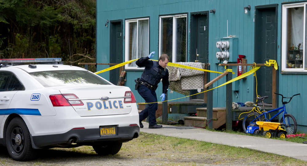 Juneau Police Department Sgt. Krag Campbell investigates the scene of a shooting at the Coho Park Apartments on Friday. Juneau police say a 19-year-old woman was shot in the head on Friday afternoon at the Mendenhall Valley apartment complex, but survived and was medevaced to Anchorage.