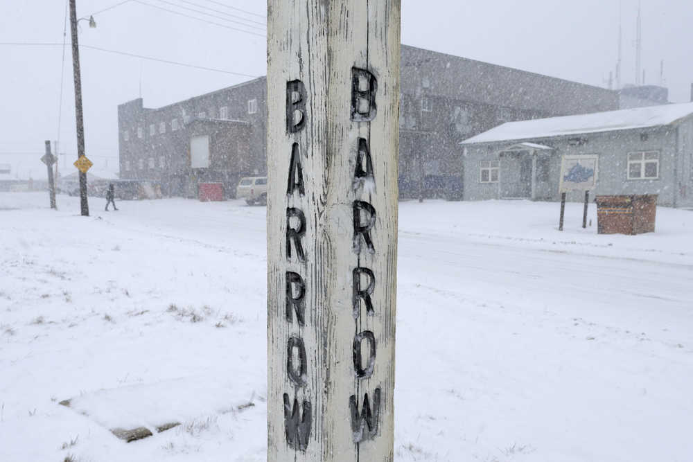 In this Oct. 10, 2014 file photo, snow falls around a sign in Barrow, Alaska. Residents in Barrow, the nation's northernmost community, have voted to change the name of their city back to its traditional Inupiaq name of Utqiagvik.
