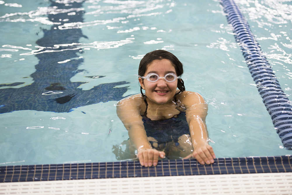 ADVANCE FOR WEEKEND EDITIONS, OCT. 15-16 - In This Sept. 22, 2016 photo, Bethel Regional High School's Skylar Sargent poses in the pool during a morning practice in Bethel, Alaska. Sargent approached the Bethel City Council in fourth grade to ask for a swimming pool; she's now a 10th grader and a member of Bethel's first swim team. (Katie Basil/KYUK via AP)