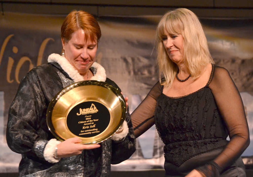 Kris Sell (left), a lieutenant with the the Juneau Police Department, accepts the Juneau Chamber of Commerce's citizen of the year award from Sharon Burns during the chamber's annual dinner Friday in Centennial Hall.