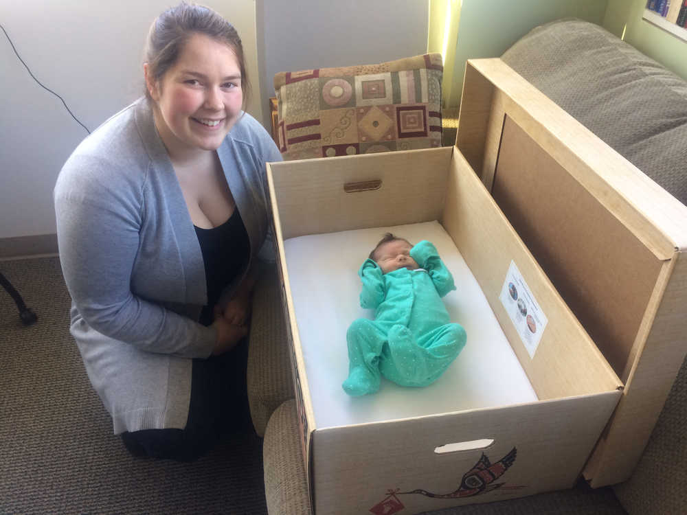 Kaity Conrad by her daughter Amelia who rests in a baby box given out by Bartlett Regional Hospital Foundation.