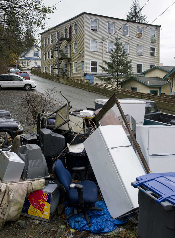 Appliances and furniture sit in a large pile in a parking lot owned by the Bergmann Hotel on Thursday. Black bears have been making a nightly appearance in the area.