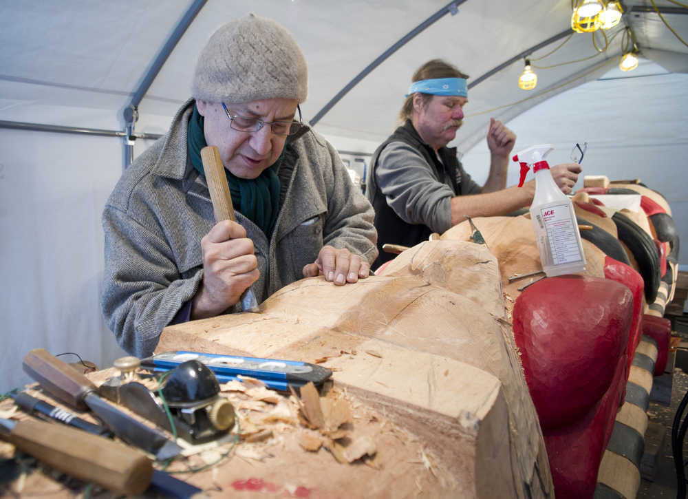 Lead carver Mic Beasley, left, and carver Fred Fulmer work on a healing totem pole at Harborview Elementary School through the summer. The totem will be erected at Gastineau Elementary School as a remembrance of the Tlingit graves the school was built on.