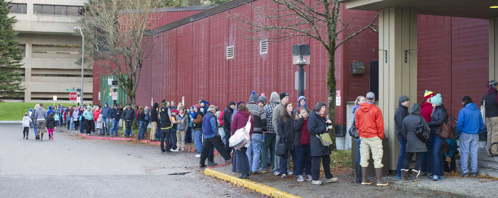 In this file photo from  in November 2013, Juneau residents wait in line outside Centennial Hall for the annual Ski Sale hosted by the Juneau Ski Club and Ski Patrol.