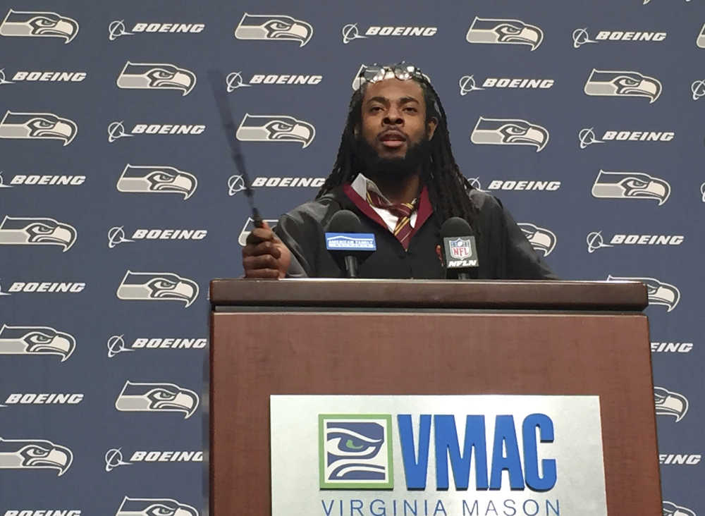 Seattle Seahawks NFL football cornerback Richard Sherman talks to reporters while dressed as a wizard from the Harry Potter movie and book series, Wednesday, Oct. 26, 2016, at Seahawks headquarters in Renton, Wash. From Sunday night to Monday morning, Sherman was suffering from dehydration and fatigue on the flight back to Seattle after being on the field for nearly 100 plays and more than 46 minutes of game time in the Seahawks' 6-6 tie with the Arizona Cardinals. (Stephen Cohen/seattlepi.com via AP)