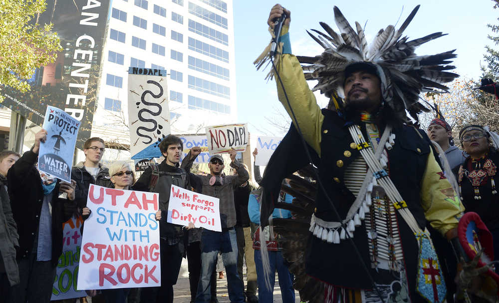 Protesters demonstrate at the Gallivan Center in Salt Lake City in support of the Standing Rock Sioux against the Dakota Access Pipeline, Monday, Oct. 31, 2016. Following the rally, the diverse group of over 100 marched half a block to the Wells Fargo Center building, where they held a protest in the lobby. Wells Fargo is one of several major banks financing the pipeline. (Al Hartmann/The Salt Lake Tribune via AP)