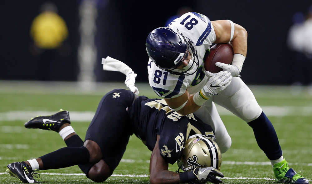 Seattle Seahawks tight end Nick Vannett (81) is stopped by New Orleans Saints cornerback De'Vante Harris (21) in the second half of an NFL football game in New Orleans, Sunday, Oct. 30, 2016. (AP Photo/Butch Dill)