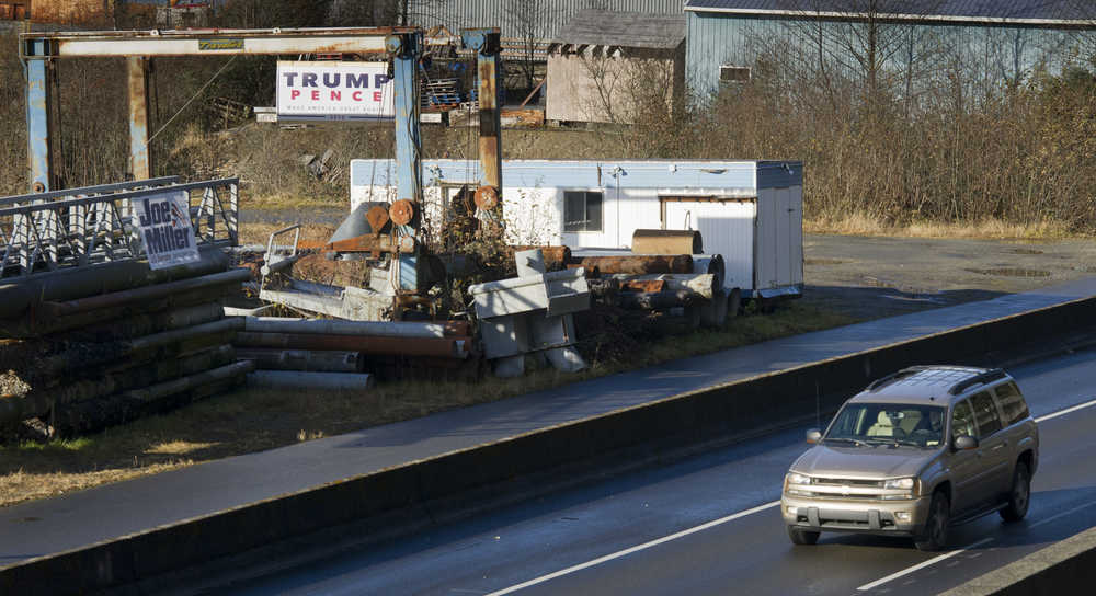 A signs for presidential candidate Donald Trump and U.S. Senate Candidate Joe Miller hang next to Egan Drive on Wednesday.