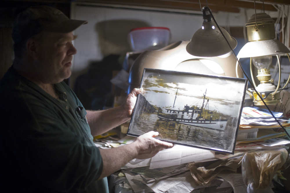 Russell Peterson shows a picture on Thursday, Nov. 3, 2016, of what his 1926 boat, the Seal, looked like in its prime. Peterson has lived in Aurora Harbor for 13 years.