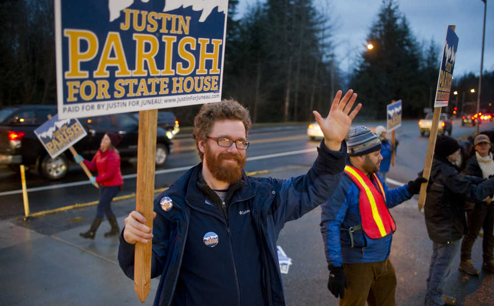 District 34 candidate Justin Parish waves to evening commuters at the corner of Egan Drive and Mendenhall Loop Road on the eve on the national and state elections Monday, Nov. 7, 2016.