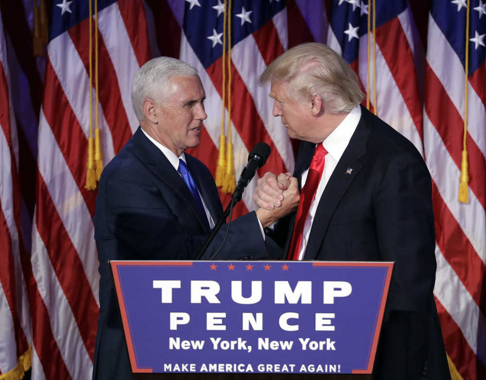 President-elect Donald Trump shakes hands with Vice President-elect Mike Pence as he gives his acceptance speech during his election night rally, Wednesday, Nov. 9, 2016, in New York. (AP Photo/John Locher)