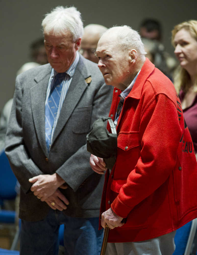 Veterans Howard Colbert, left, and Pat Carothers listen to the benediction at Veterans Day ceremonies at Centennial Hall on Friday. Carothers served in the WWII, Korea and Vietnam Wars.