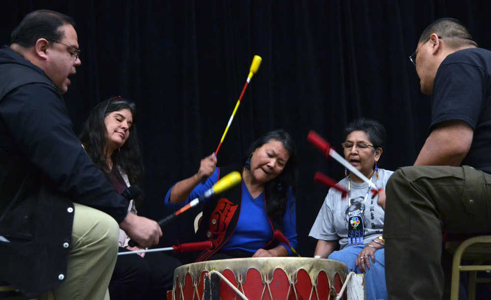 Noreen Otnes (center), a recovering addict, pounds a drum during a Juneau Reentry Coalition community get together Saturday afternoon. Playing the drums helps "heal the spirit," according Justin McDonald (left), who led the drum group.