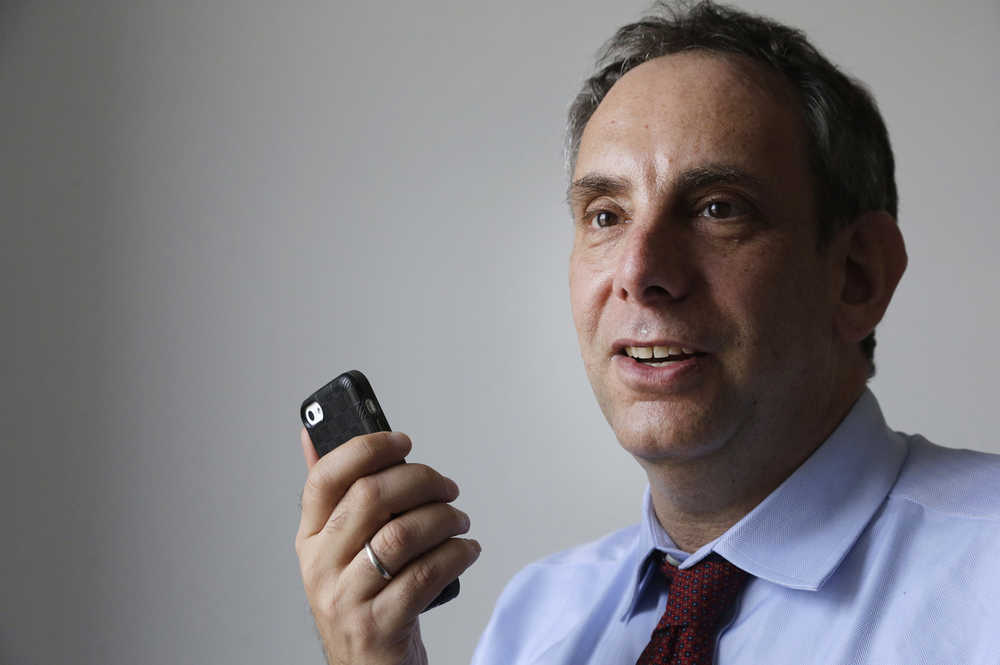 In a March 25, 2015 file photo, StoryCorps founder Dave Isay demonstrates how to record a story using a smartphone app in the Brooklyn borough of New York. The oral history project's "Great Thanksgiving Listen 2016" is charging Americans, particularly teens, to use the holiday weekend to record a conversation with a grandparent or another elder on their feelings about the election.